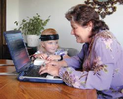 A woman and child using a laptop computer.