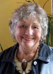 A woman with grey hair wearing a necklace.